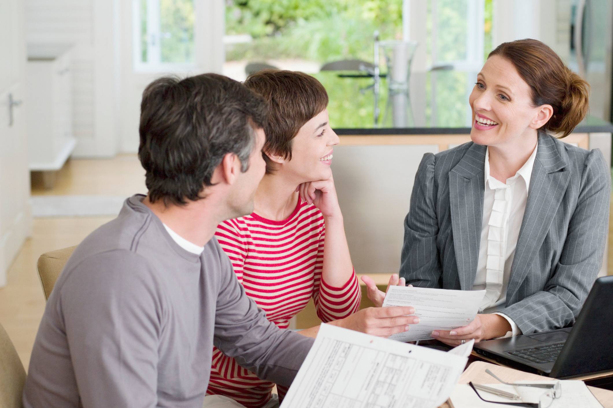 Couple consulting with a professional in a bright office setting.