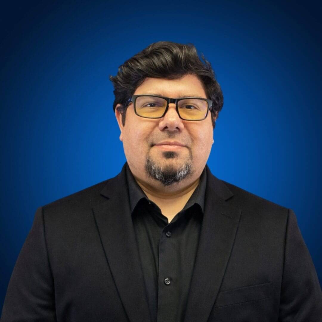 Man in black suit with glasses.
