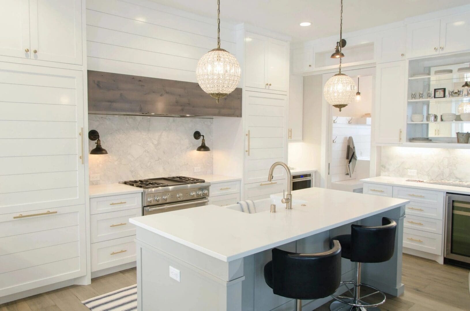 A modern kitchen featuring white cabinets and a spacious center island for cooking and dining