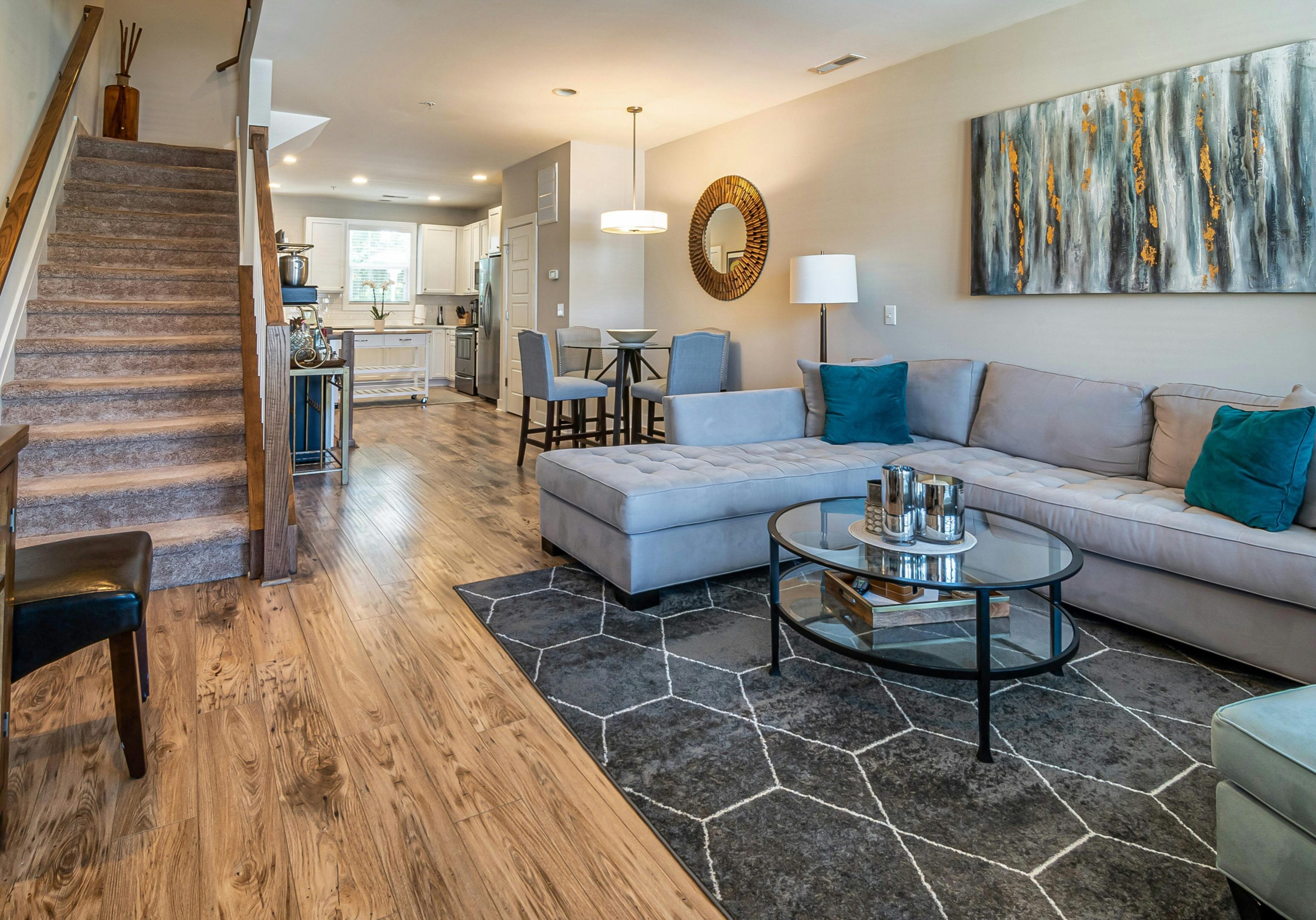 A cozy living room featuring hardwood floors and a comfortable couch, creating a warm and inviting atmosphere.